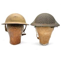 Two steel helmets, and three wooden heads,