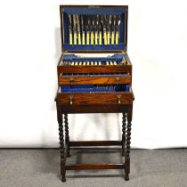 Canteen of silver plated cutlery and an oak table,