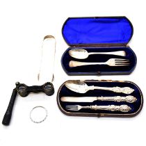 Two silver christening sets, silver sugar tongs, opera glasses and child's bangle.