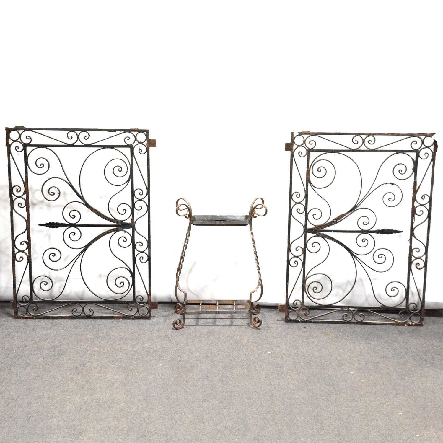 Pair of French style wrought iron panels and a metal stick stand,