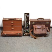 Small doctor's travel case, another case, a satchel, and a vintage blood pressure gauge