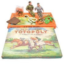 Three Action Man action figures, one in parts, and two board games