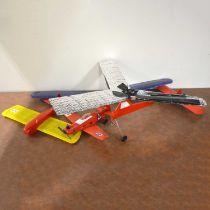 Three model aircraft airframes, with small glow engine