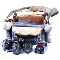 Camera bag containing Nikon F-601 35mm DSLR Camera with 28-80mm lens attached, a 80-200mm Nikon