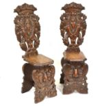 Pair of late 19th Century European oak hall chairs,