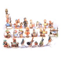 Collection of fifteen Hummel figurines and a lamp base