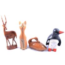 Three boxes of carved wooden animal ornaments