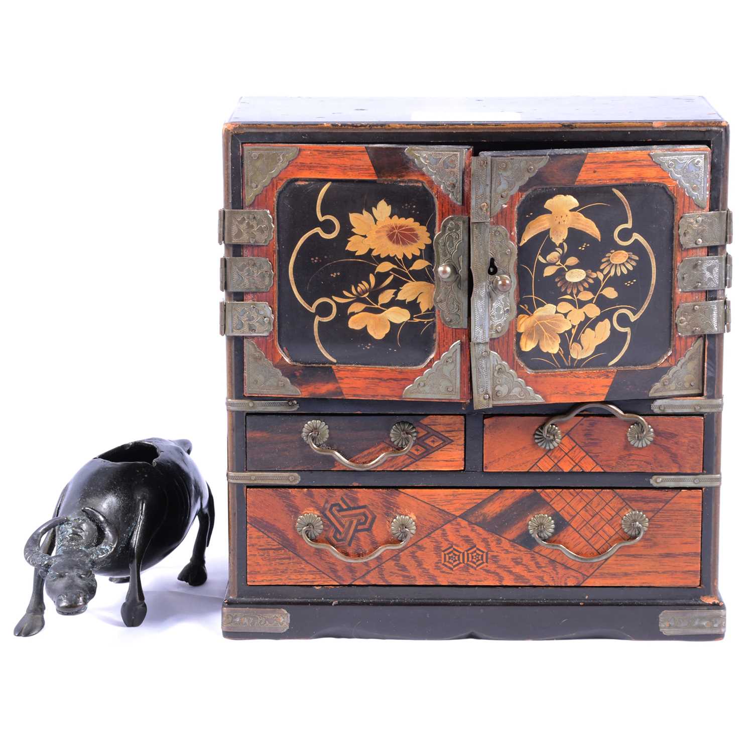 Chinese bronze model of an ox, and a Japanese lacquer and marquetry table cabinet