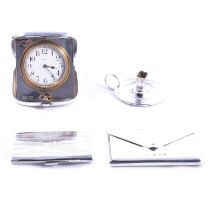 Eight-day silver cased travel clock, chamber stick, and two silver card cases