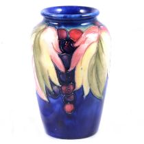 William Moorcroft for Moorcroft, a vase in the Leaf and Berry design.