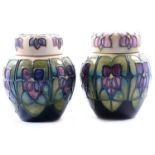 Sally Tuffin for Moorcroft Pottery, two 'Violets' pattern ginger jars and covers