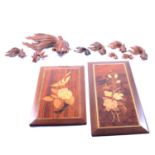 Nine various Chinese carved wooden models of fish, and two marquetry panels,
