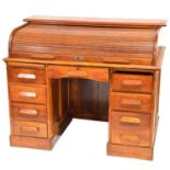 Oak roll top desk and a swivel chair,