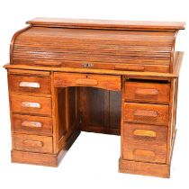 Oak roll top desk and a swivel chair,