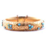 A Victorian yellow metal and turquoise half hinged bangle.