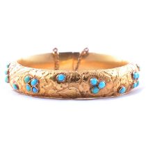 A Victorian yellow metal and turquoise half hinged bangle.
