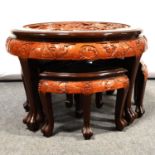 Chinese carved wood table and four nesting stools.