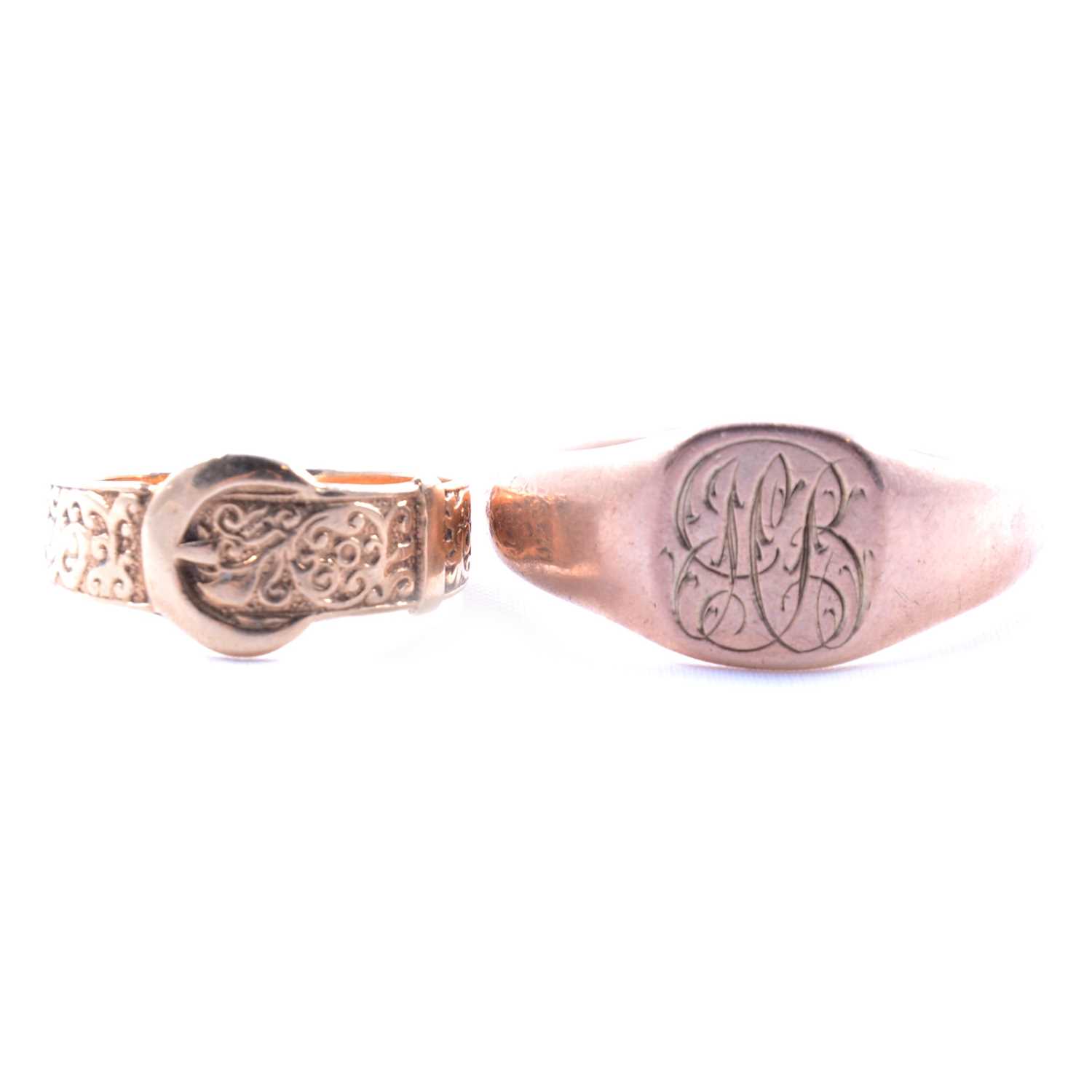 A gold signet ring and a gold buckle ring.