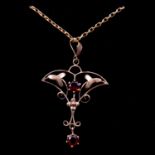 An Edwardian garnet pendant and chain.