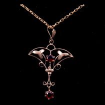 An Edwardian garnet pendant and chain.