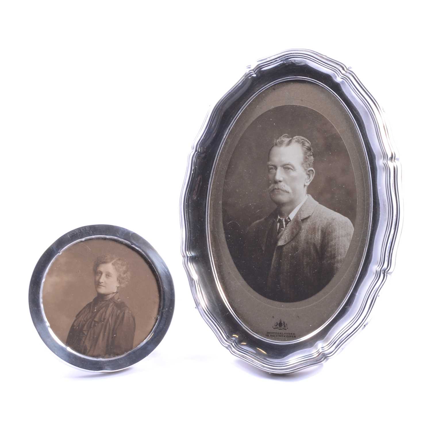 Two silver strut back photograph frames.