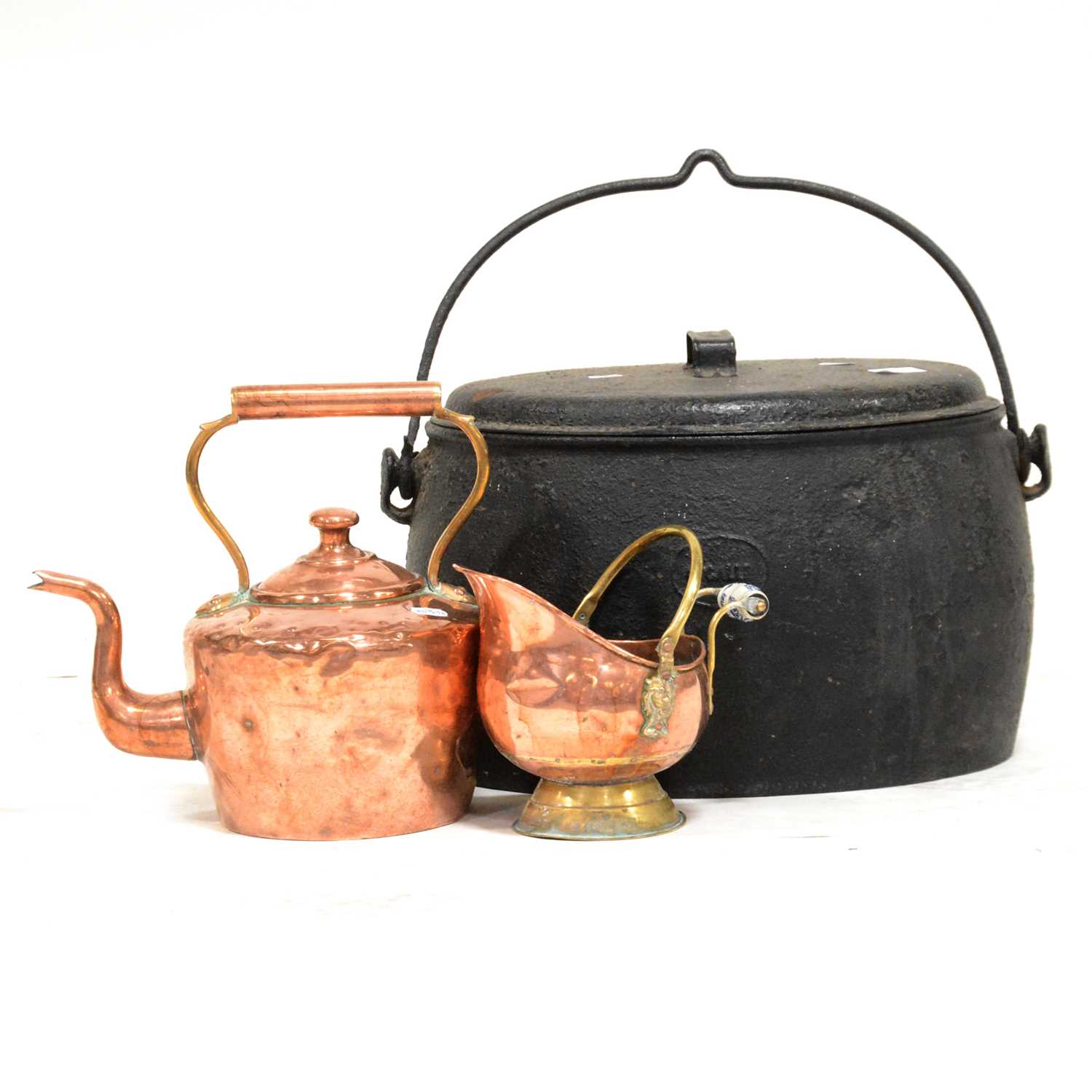 A collection of copper and cast iron wares,