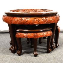 Chinese carved wood table and four nesting stools.
