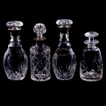 Near pair of silver-mounted decanters, another silver-mounted decanter, and others