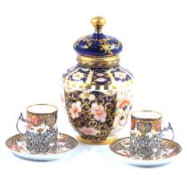 A set of six Royal Crown Derby demi-tasse in silver holders and a similar jar and cover.