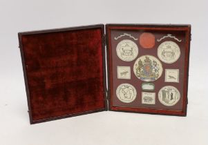 A heraldic crest display, in fitted leather case, case 15cm high, 13.5cm wide