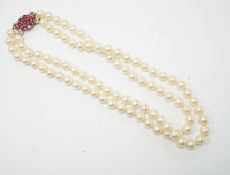 A double strand cultured pearl choker necklace with yellow and white metal, ruby and diamond cluster