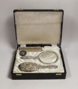 A cased modern silver mounted four piece mirror and brush set, Birmingham, 1985.
