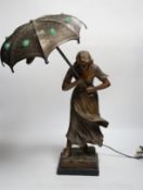 A spelter Art Nouveau-style figural table lamp, lady with an umbrella, 46cm high