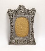 A Burmese white metal mounted shaped rectangular photograph frame, decorated with elephants and