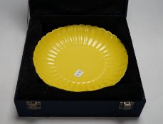 A Chinese yellow-ground fluted dish, housed in a fitted case, 20cm in diameter