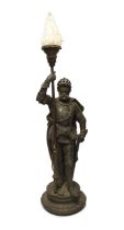 A spelter table lamp of a knight in armour carrying torch, with flame glass shade, approx 75cm high