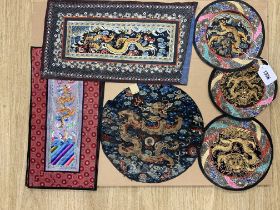 A group of five Chinese gold thread and polychrome silk embroidered circular mats, embroidered