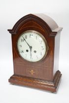 An Edwardian inlaid mahogany mantel clock striking on a coiled gong, 37cm