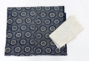 A tablecloth with a wide crocheted border and a blue and white Japanese panel decorated with mons,