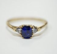 A yellow metal and single stone oval cut sapphire set ring, with two stone heart shaped diamond