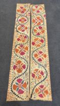 A pair of Uzbekistan long wide panels, both embroidered in mostly red, coral and blue with large