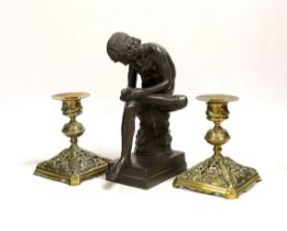 A bronze model of Spinario and a pair of Victorian dwarf candlesticks, lozenge mark to base, tallest