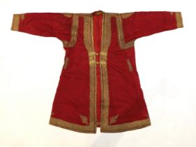 A late 19th century gentleman’s quilted red silk Indian Chogha, embroidered with ornate gold and