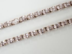 A modern 925 gilt metal and oval cut morganite set line necklace, 46cm.