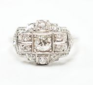 An Art Deco style white metal and millegrain set diamond cluster ring, size N/O, gross weight 4.1