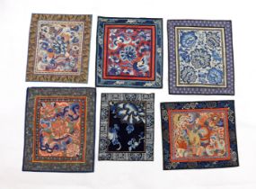 Six large Chinese silk embroidery mats with silk brocade borders, mostly embroidered flowers and