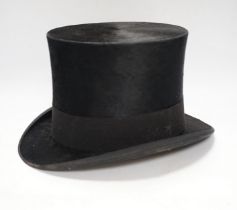 A top hat, in leather case