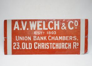 An enamel advertising sign: A.V. Welch & Co, and an Eastport Lane aluminium street sign, latter