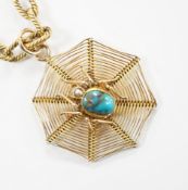 An early 20th century 9ct, turquoise and seed pearl set 'spider and web' pendant, 30mm, on a