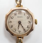 A lady's 1920's 9ct gold Rolex manual wind wrist watch, with sunburst Arabic dial, on a 9ct twin